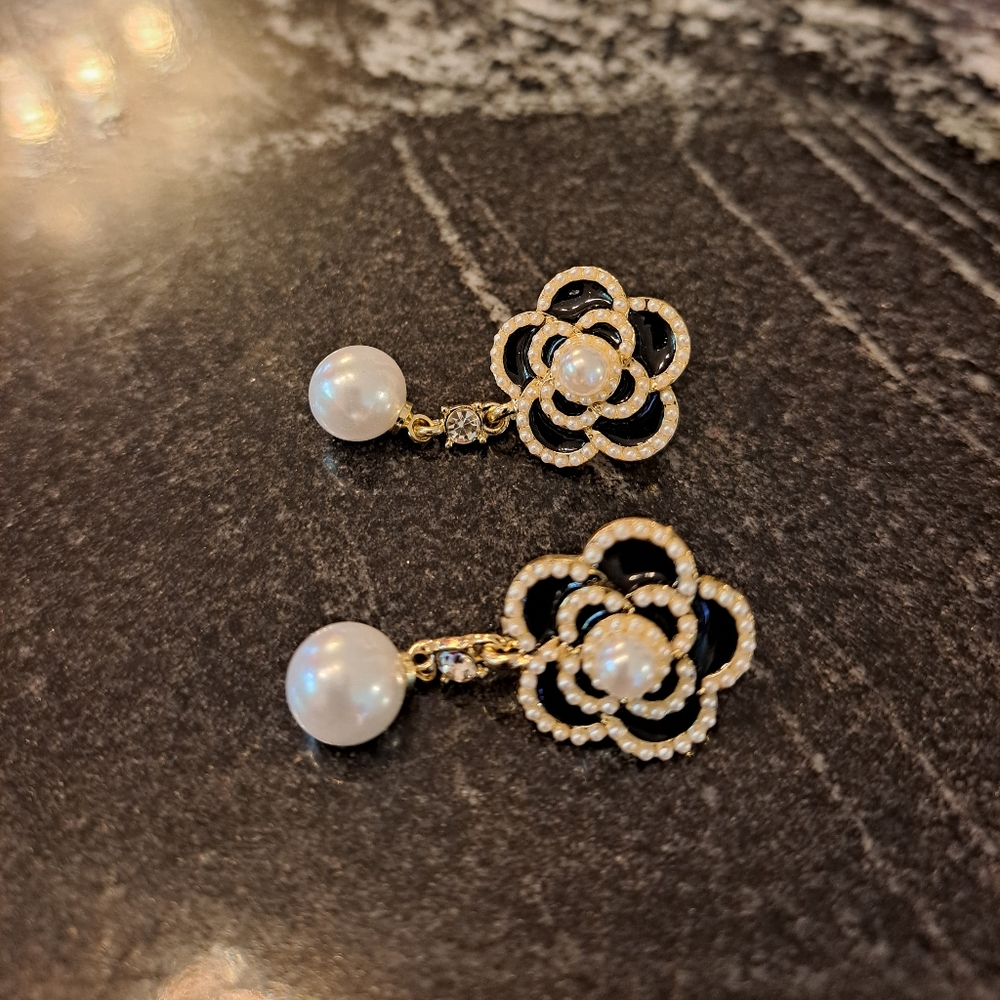 Black flower with pearl like dangling earrings